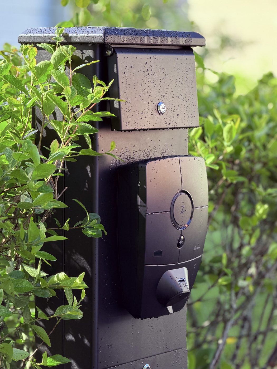InfraPole pole outdoors — heating cabinet on top, charger below